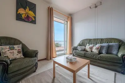 a living room with two couches and a coffee table at Miradouro House By Sam Houses in Ponta do Sol