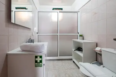 a white bathroom with a sink and a toilet at Miradouro House By Sam Houses in Ponta do Sol