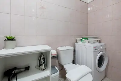 a bathroom with a toilet and a washing machine at Miradouro House By Sam Houses in Ponta do Sol