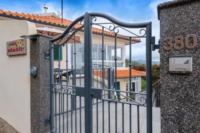 a gate to a house with a building at Miradouro House By Sam Houses in Ponta do Sol