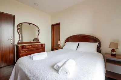 a bedroom with a bed with two towels on it at Miradouro House By Sam Houses in Ponta do Sol
