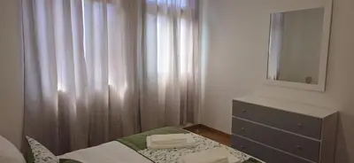 a bedroom with a bed and a dresser and a mirror at Pôr do Sol II in Porto Moniz