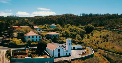 an aerial view of a house with a church at Pôr do Sol II in Porto Moniz