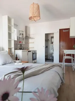 a bedroom with a bed with flowers on it at The Studio in Aljezur