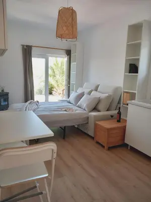 a living room with a couch and a table at The Studio in Aljezur