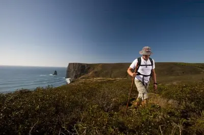 a man walking on a hill near the ocean at The Studio in Aljezur