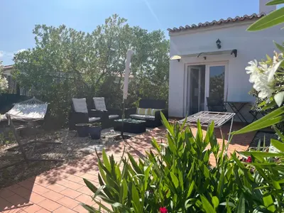 a patio with chairs and a couch in a yard at The Studio in Aljezur