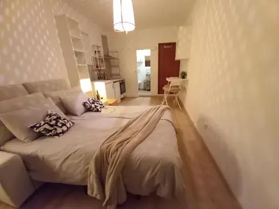 a bedroom with a large bed and a couch at The Studio in Aljezur