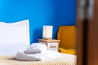 a bedroom with a bed with a lamp and a chair at GuestReady – Rustic Charm in Peaceful Madeira in Porto da Cruz
