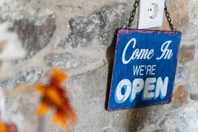 a sign that says come in we are open at GuestReady – Rustic Charm in Peaceful Madeira in Porto da Cruz