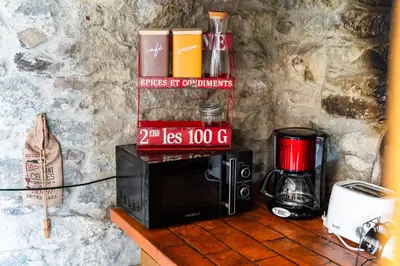 a microwave sitting on a counter next to a wall at GuestReady – Rustic Charm in Peaceful Madeira in Porto da Cruz