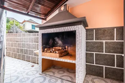 a stone fireplace in a patio at Golden Coast by Homie in Calheta