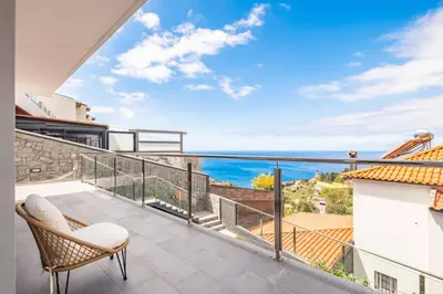 a balcony with a view of the ocean at Villa Vellure by Homie in Funchal