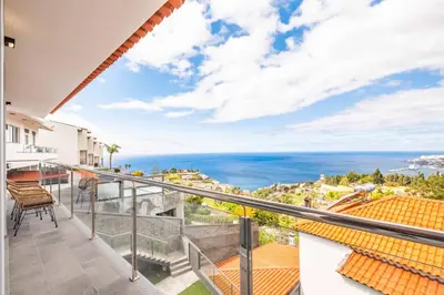 a balcony with a view of the ocean at Villa Vellure by Homie in Funchal