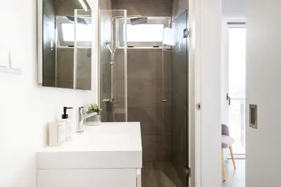a bathroom with a white sink and a mirror at Villa Vellure by Homie in Funchal