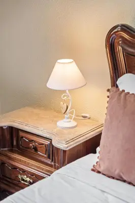 a table with a lamp on it next to a bed at Valley Nest by Zest and Guest in Ribeira Brava