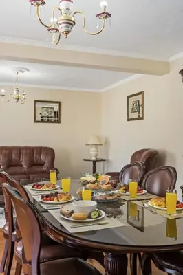 a dining room table with plates of food on it at Valley Nest by Zest and Guest in Ribeira Brava