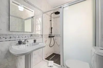 a white bathroom with a sink and a shower at Valley Nest by Zest and Guest in Ribeira Brava