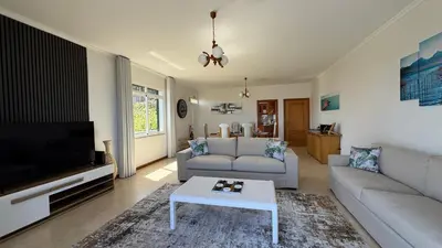 a living room with a couch and a tv at Villa Serenity in Porto Moniz