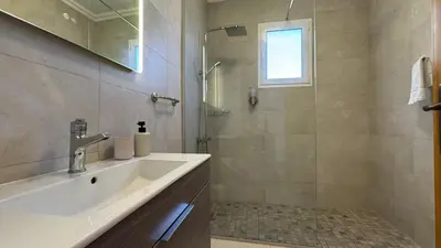 a bathroom with a sink and a shower at Villa Serenity in Porto Moniz