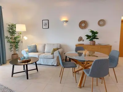 a living room with two tables and a couch at Lagos Bay Apartment in Lagos