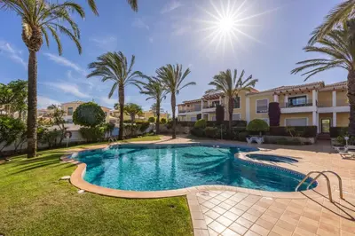 a swimming pool in a yard with palm trees at Lagos Bay Apartment in Lagos