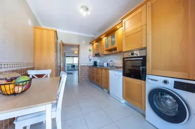 a kitchen with a table and a washing machine at Lagos Bay Apartment in Lagos