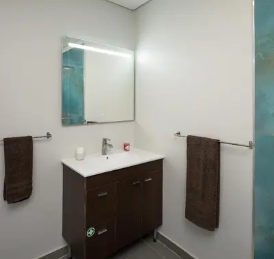 a bathroom with a sink and a mirror at Casa da Relva com Piscina Aquecida Interna in Arco da Calheta