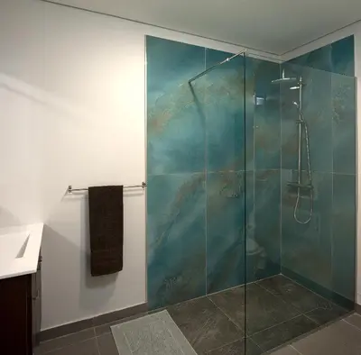 a bathroom with a shower with a glass door at Casa da Relva com Piscina Aquecida Interna in Arco da Calheta