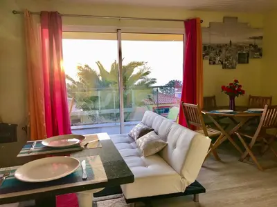 a living room with a couch and a table and a window at Casa da Relva com Piscina Aquecida Interna in Arco da Calheta