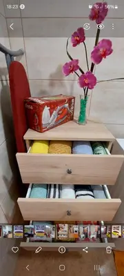 a dresser with a vase of flowers on top of it at Apartamento Villa 4 in Ponta do Sol