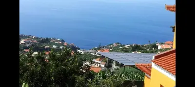 a view of the ocean from a town with houses at Apartamento Villa 4 in Ponta do Sol