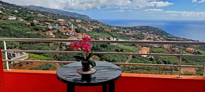a table with a vase on top of a balcony at Apartamento Villa 4 in Ponta do Sol