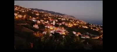 a group of houses on a hill at night at Apartamento Villa 4 in Ponta do Sol