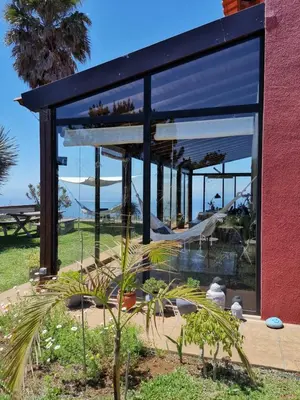 a dining room with a table and a view of the ocean at Oasis in Madeira by YMR in Raposeira do Logarinho