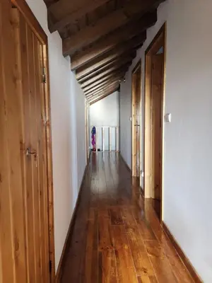 a long hallway with wooden floors and wooden ceilings at Oasis in Madeira by YMR in Raposeira do Logarinho