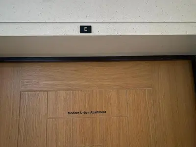 a wooden door with a sign on top of it at Modern Urban Apartment in Funchal
