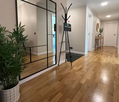 a living room with a wooden floor and a glass door at Modern Urban Apartment in Funchal