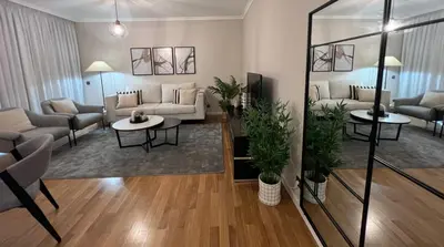 a living room with a couch and chairs and tables at Modern Urban Apartment in Funchal