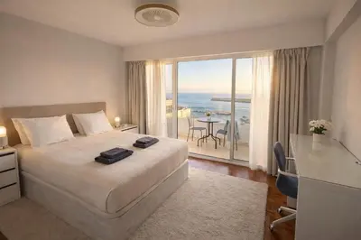 a hotel room with a bed and a view of the ocean at Vista Marina Funchal in Funchal