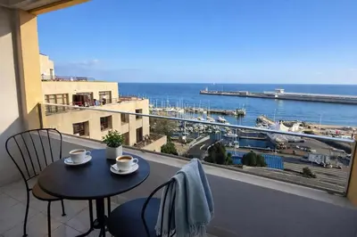 a kitchen with white cabinets and a sink at Vista Marina Funchal in Funchal