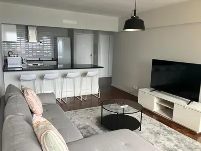 a living room with a couch and a table at Vista Marina Funchal in Funchal