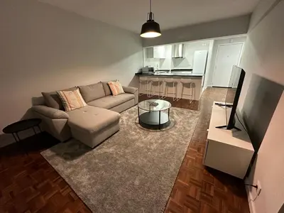 a living room with a couch and a kitchen at Vista Marina Funchal in Funchal