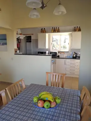 a kitchen with a table with a plate of fruit on it at Villa Sorriso in Luz