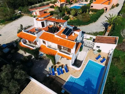 an aerial view of a house with a swimming pool at Fawlty Towers in Luz