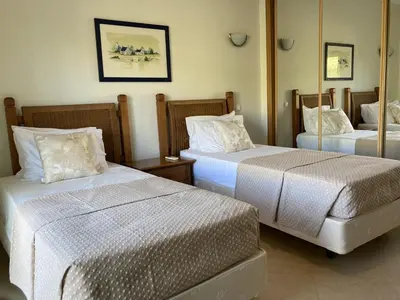a hotel room with two beds and a window at Boavista 59A in Lagos