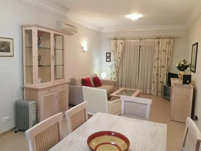 a bathroom with a toilet and a tub and a sink at Boavista 59A in Lagos