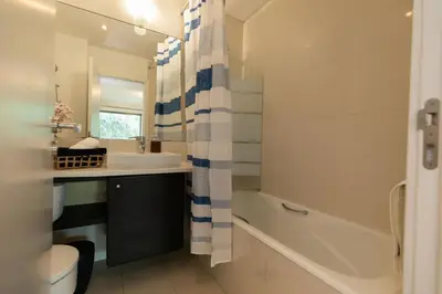 a bathroom with a sink and a tub and a toilet at Monumental Garden Loft by Rent-a-Key in Funchal