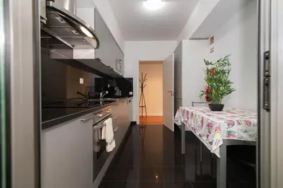 a kitchen with a table with a table cloth at Monumental Garden Loft by Rent-a-Key in Funchal