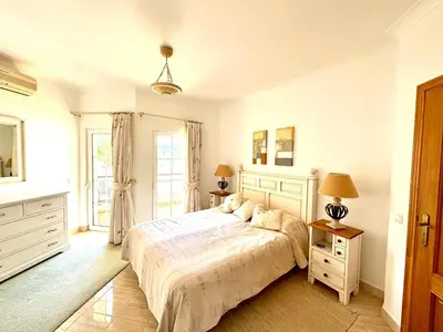 a bedroom with a bed and two night stands at Casa da Luz 9 , golf view townhouse in Vila do Bispo